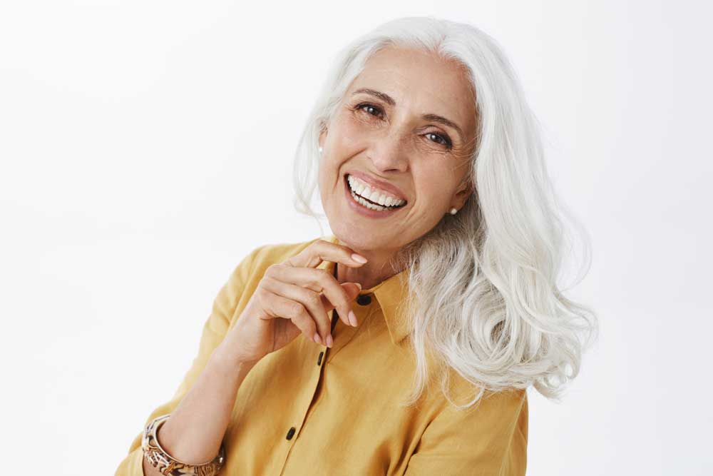 Beautiful Grey Haired Lady With Yellow Shirt Smiling