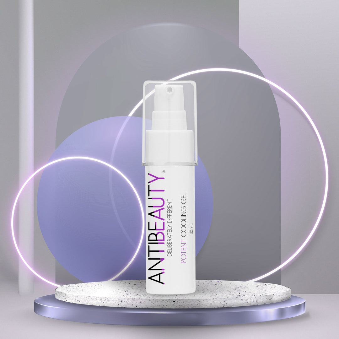 AntiBeauty Potent Cooling Gel - a gentle facial gel for sensitive and hormonal skin - on an stone podium in front of a pastel purple glowing background.