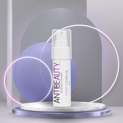AntiBeauty Potent Cooling Gel - a gentle facial gel for sensitive and hormonal skin - on an stone podium in front of a pastel purple glowing background.
