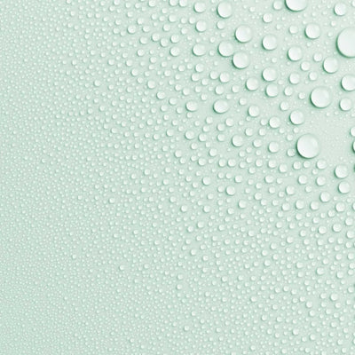 Close-up photo of AntiBeauty Reveal Clarifying Toning Mist texture, with fine mist droplets on a mint coloured background.
