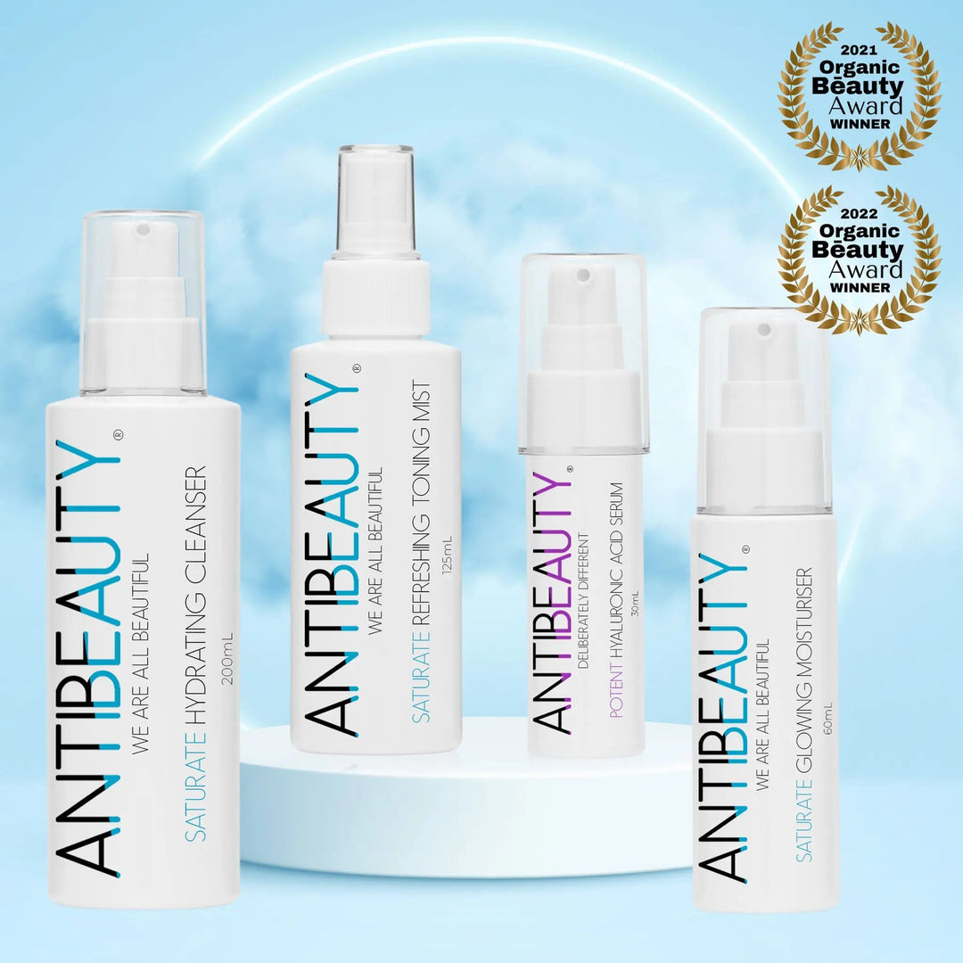 Saturate Hydrating Bundle in front of a blue background with podium and clouds, showing two award logos
