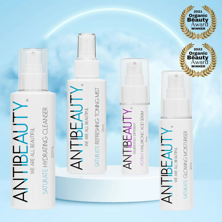 Saturate Hydrating Bundle in front of a blue background with podium and clouds, showing two award logos